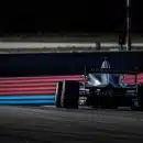 red and black f 1 race car on track during daytime