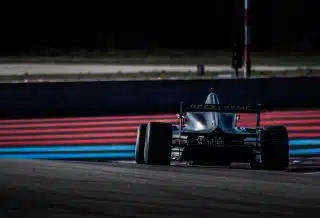 red and black f 1 race car on track during daytime